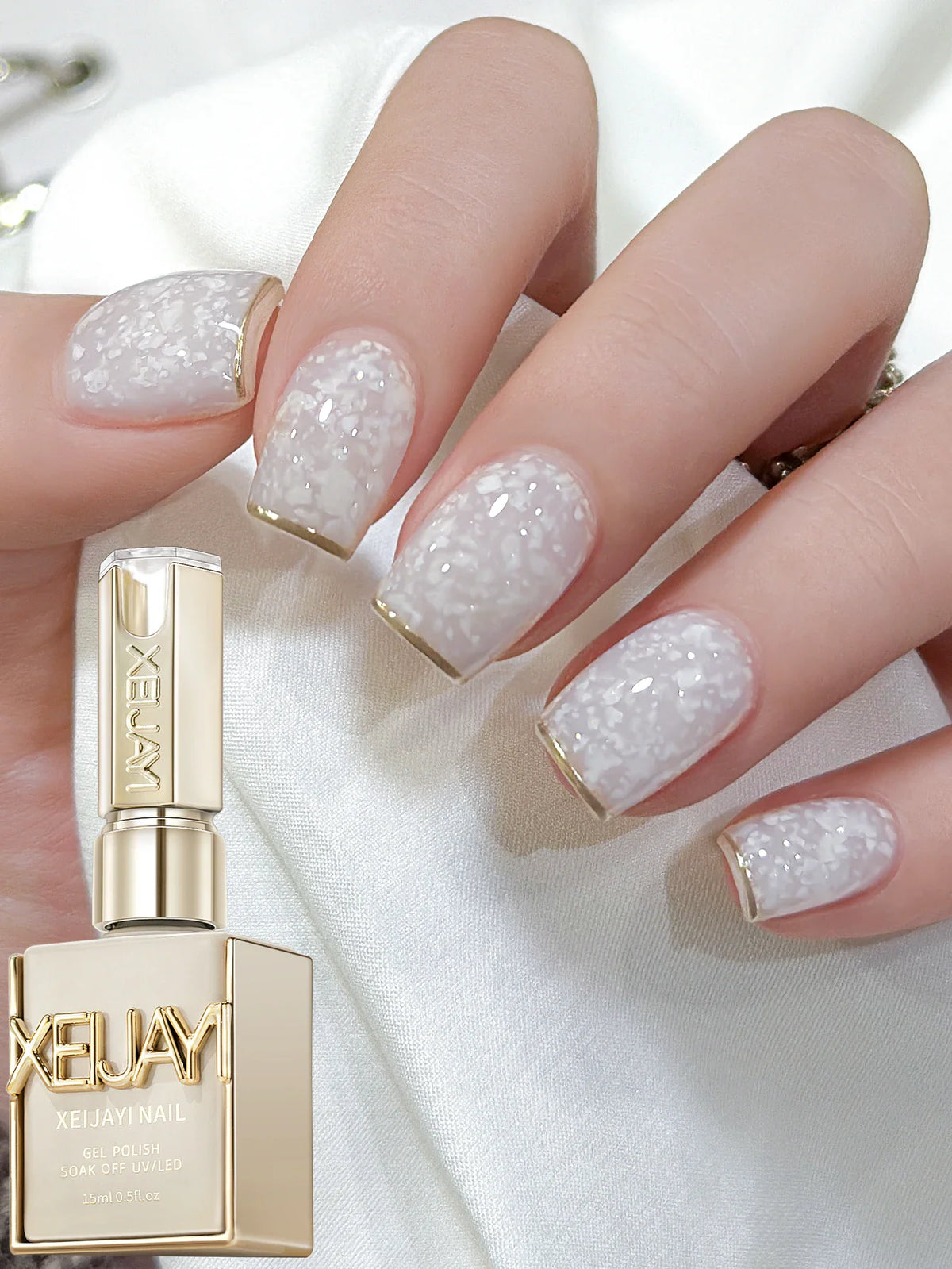 Hand showing nails painted with white eggshell gel polish next to the polish bottle