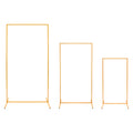 Three different sizes of gold rectangular metal display stands arranged side by side