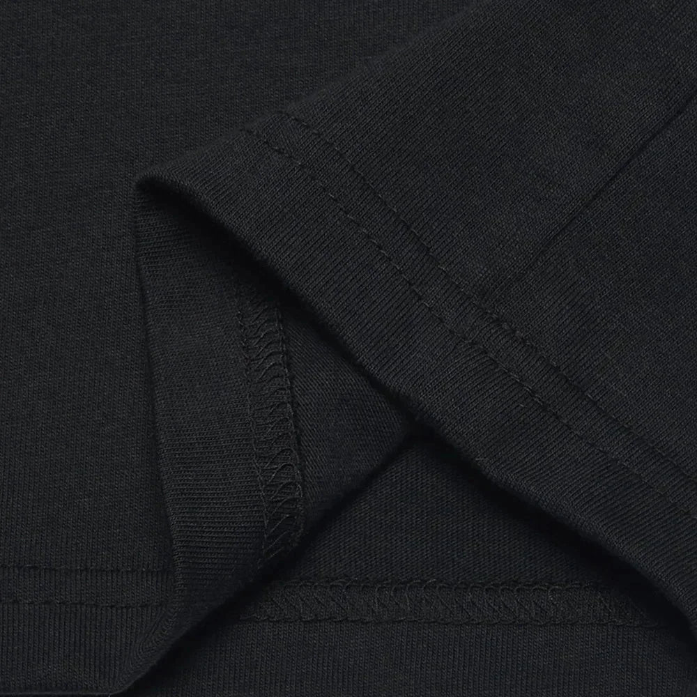 Close up of a black t-shirt hem and sleeve stitching