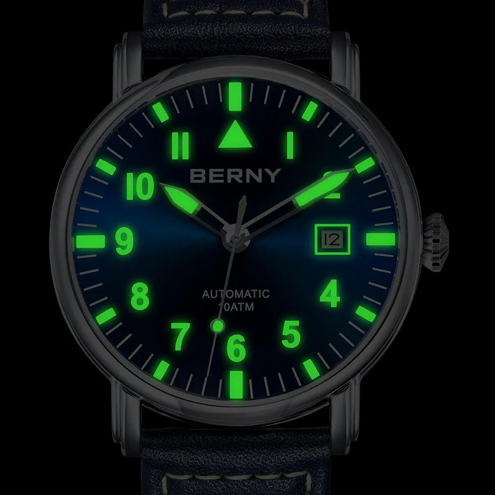 Aviation-style automatic watch with glowing luminous hands and markers on a blue dial