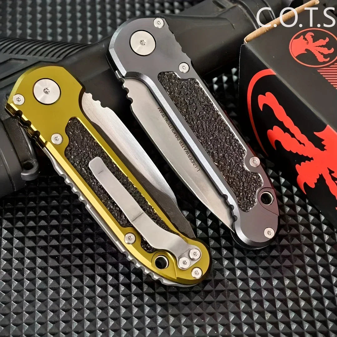 Two folding pocket knives showing their metal clips and textured handle grips in grey and olive green.