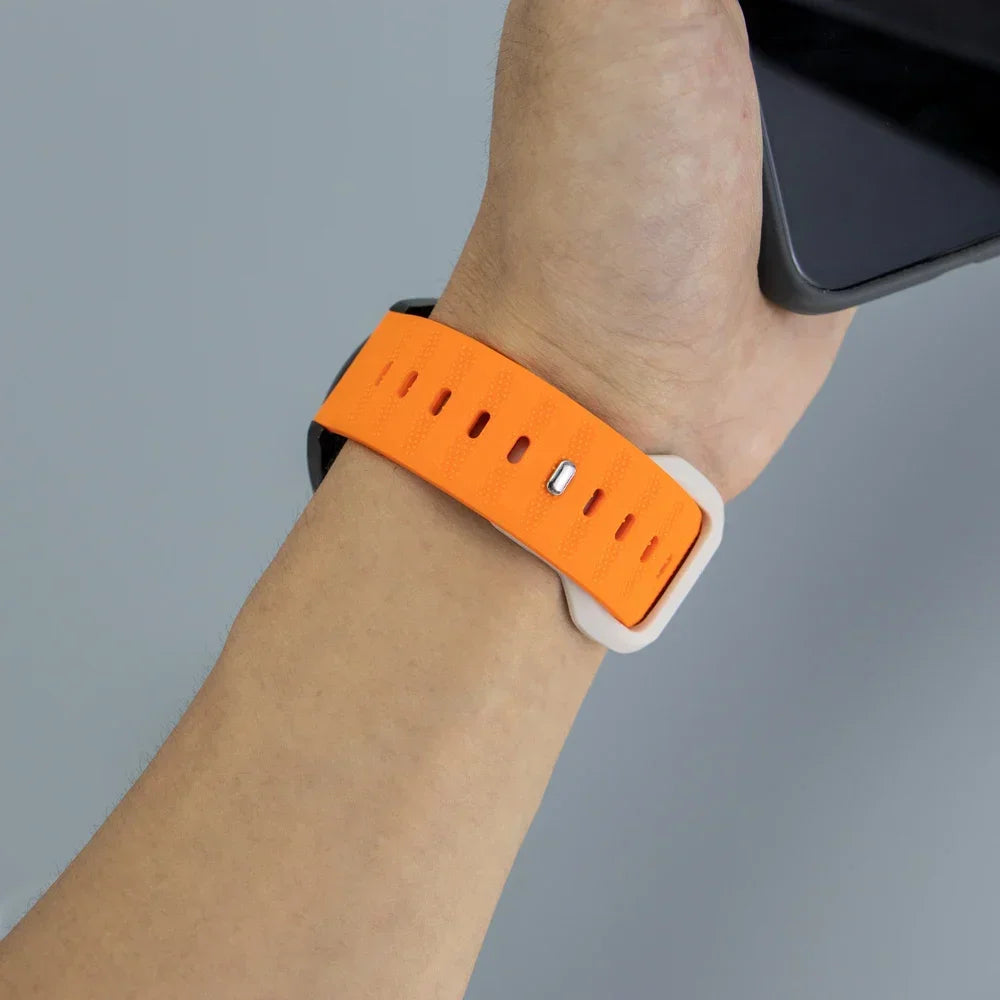 Orange and white silicone sports watch strap worn on a wrist