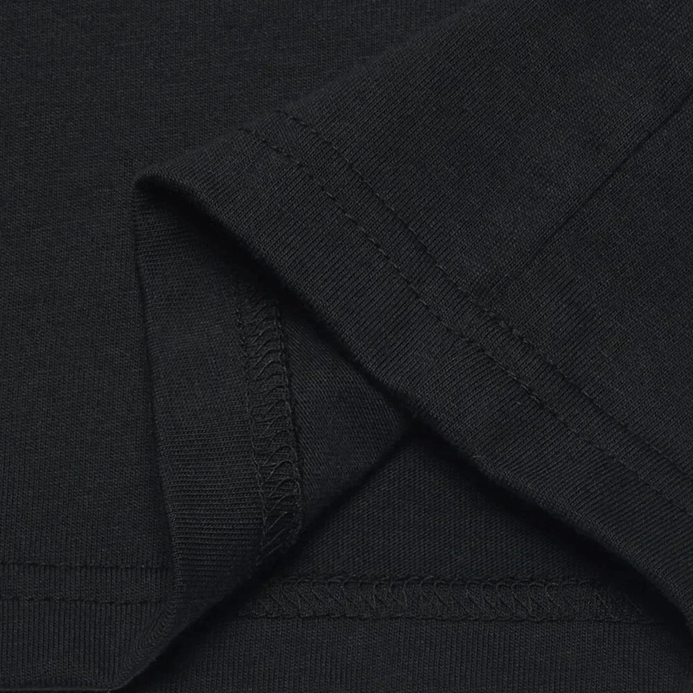 Close up of the sleeve hem on a black T-shirt