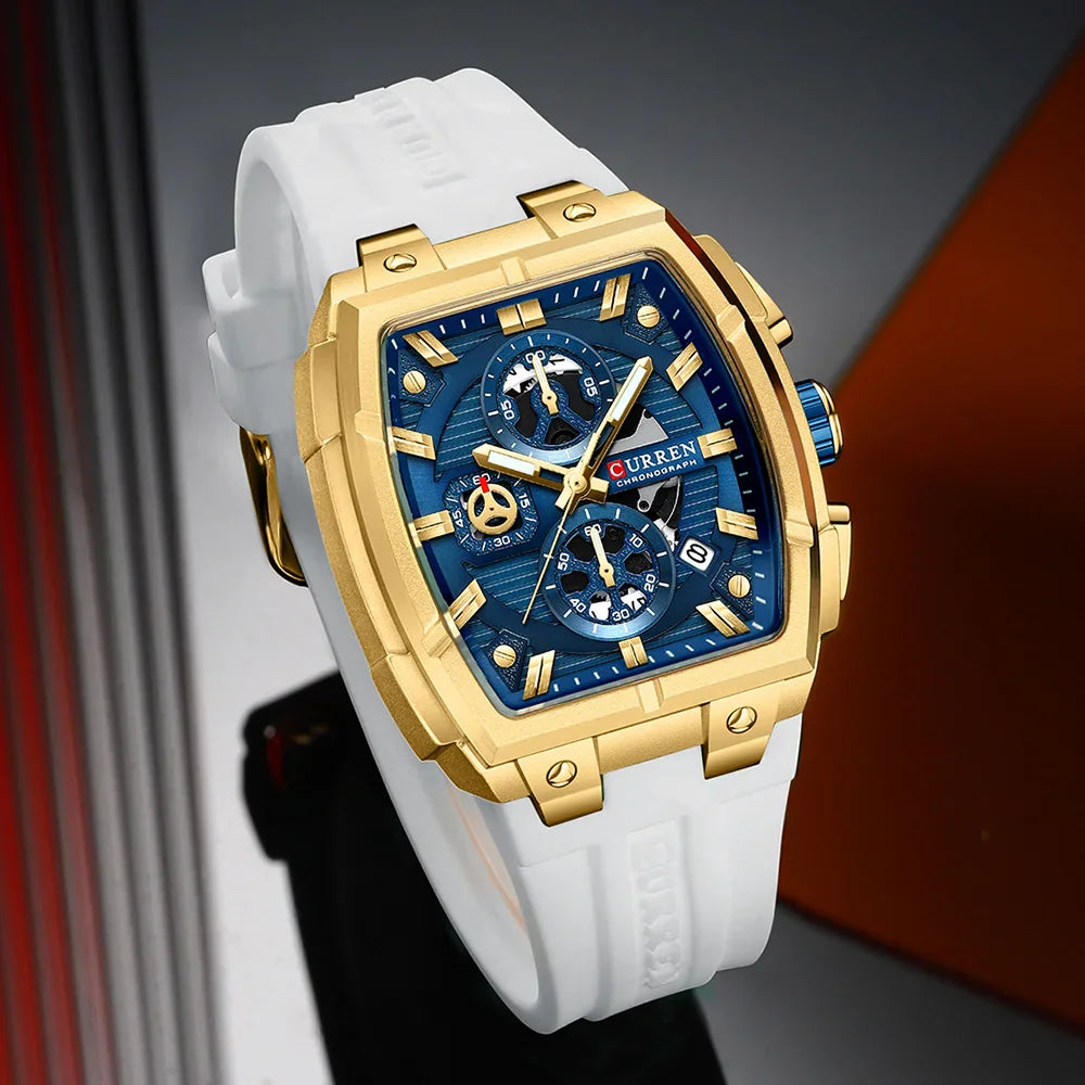 Men's square chronograph watch with gold case, blue dial, and white silicone strap