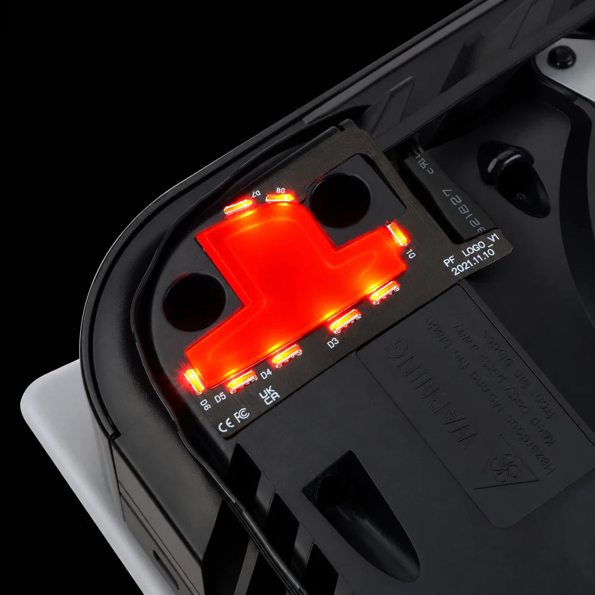 Internal view of a console with a red illuminated RGB LED logo light kit installed.