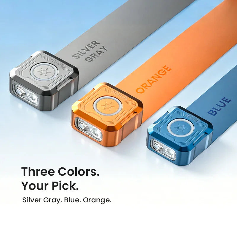 Three compact square flashlights in orange, blue, and silver metallic finishes with product name