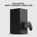 Black video game console standing vertically with a wireless controller in front on a light background