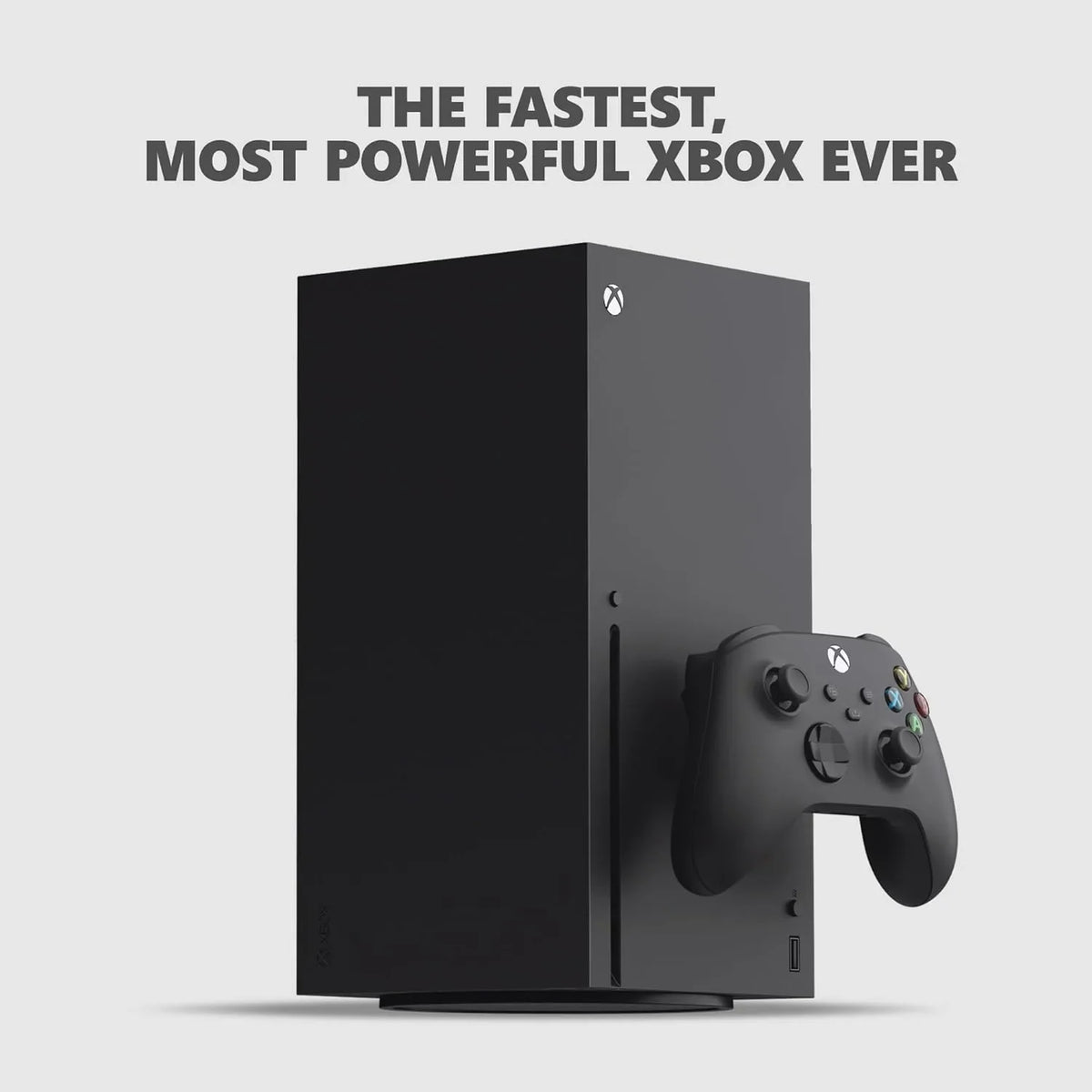 Black video game console standing vertically with a wireless controller in front on a light background