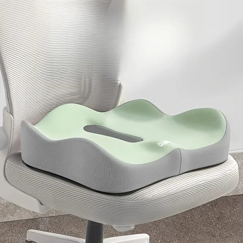 Green and grey ergonomic seat cushion on an office chair
