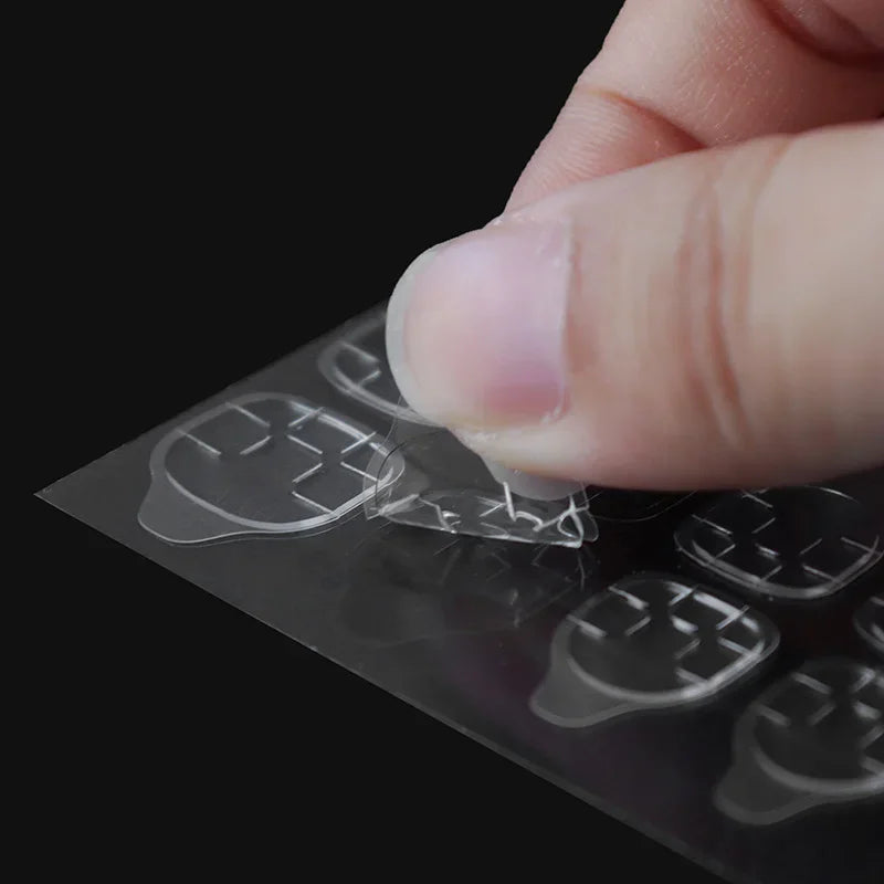 Close-up of adhesive jelly tab being peeled off a sheet
