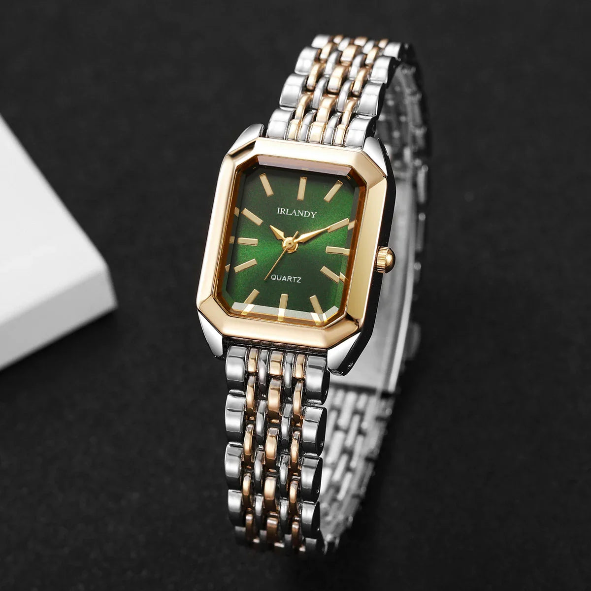 Two-tone rectangular women's quartz watch with a green dial on a black background