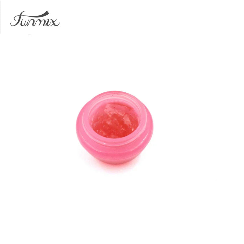 Open pink pot containing eyelash extension glue remover cream