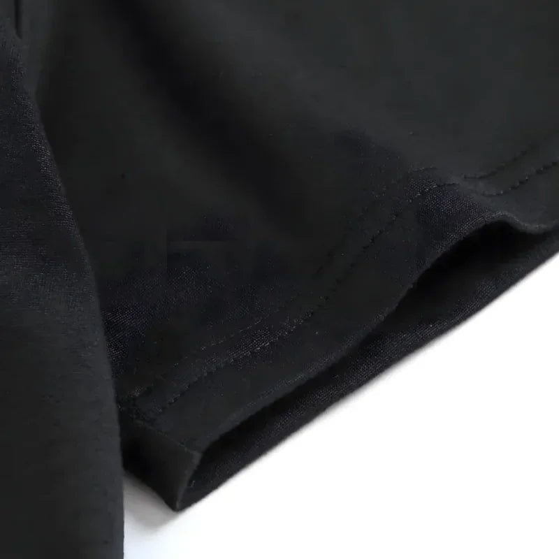 Close up of the hemline of a black cotton t-shirt
