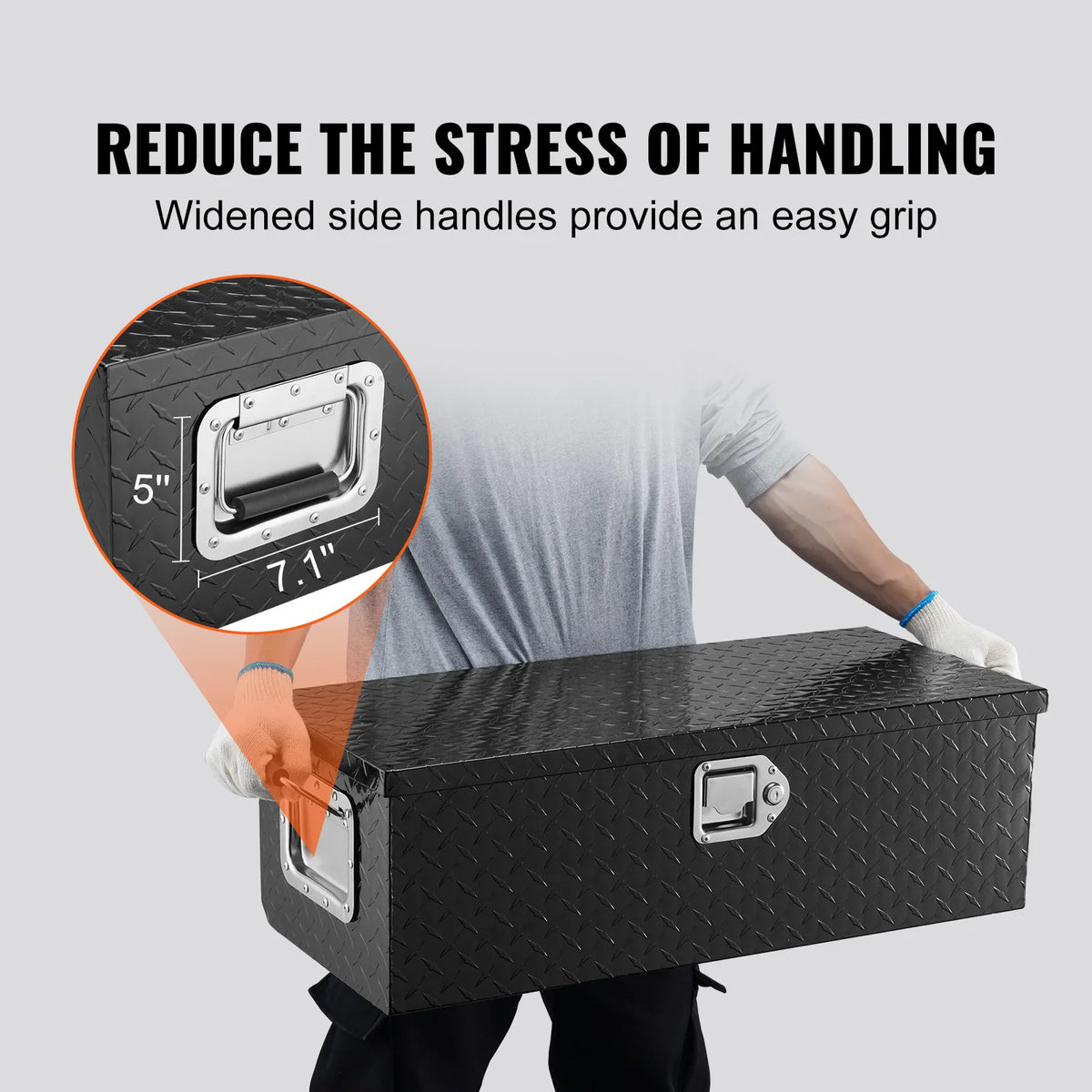 Person holding a black truck tool box by its side handle to demonstrate easy handling and grip