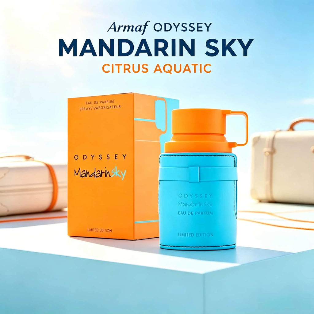 Blue and orange fragrance bottle with box and travel case in the background