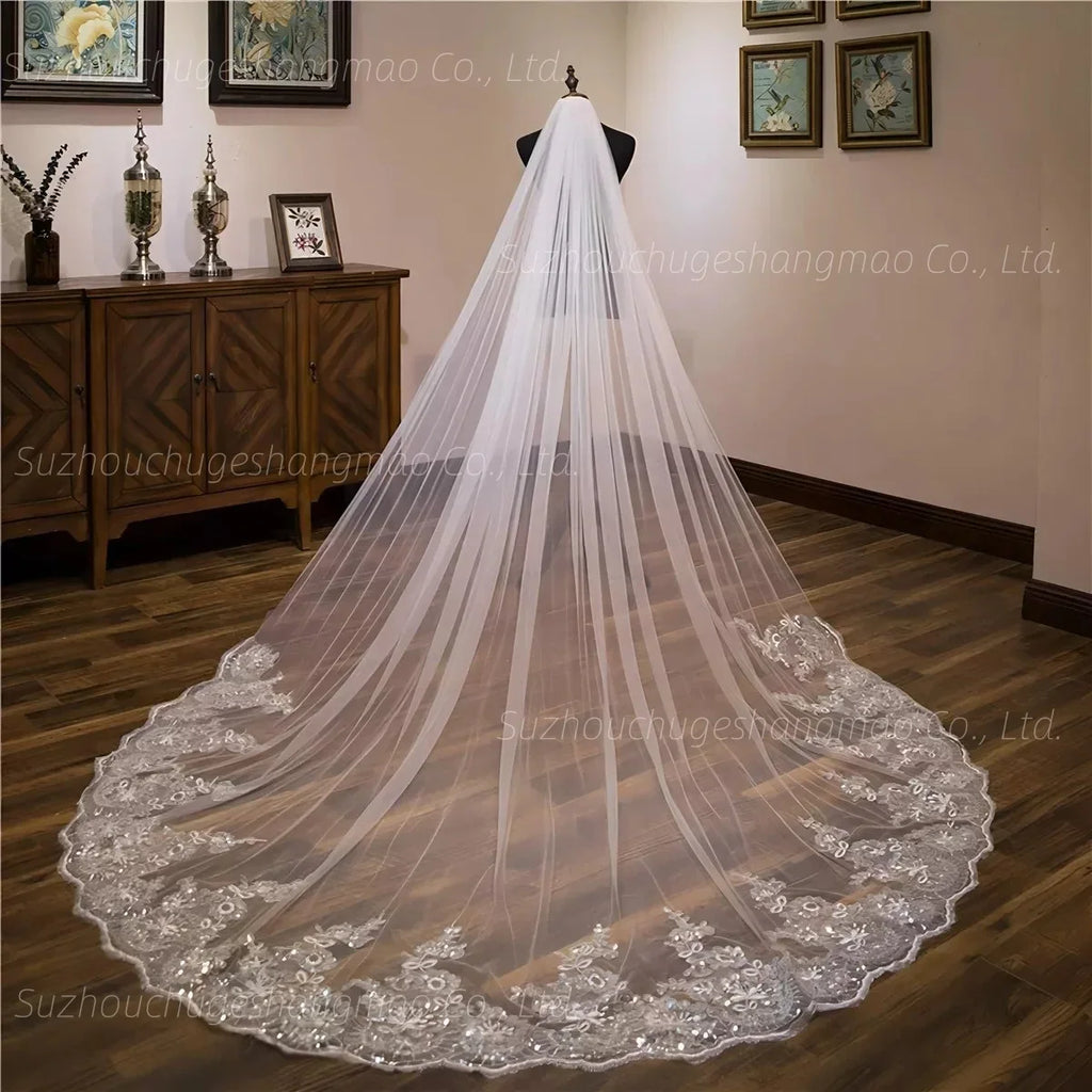 Long ivory cathedral wedding veil with lace floral appliques and bead embellishments on a mannequin
