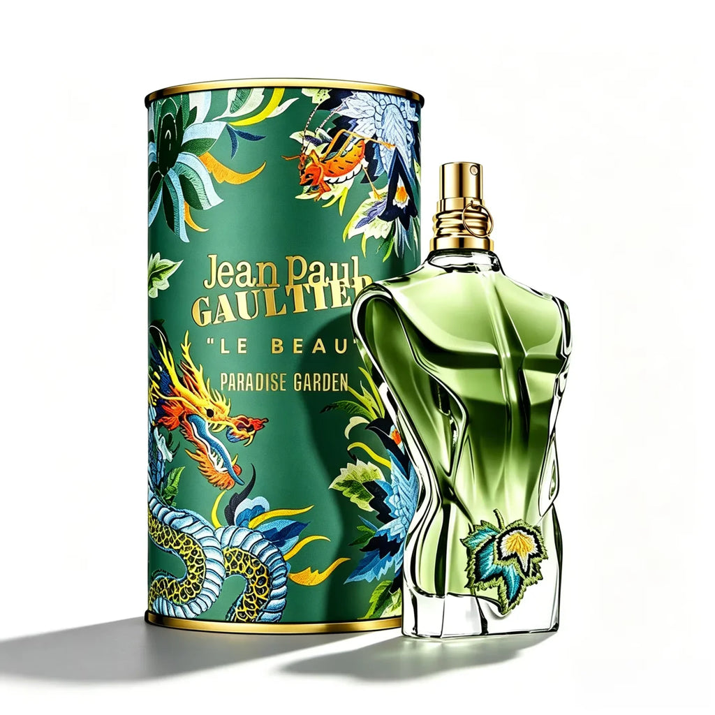 Green torso shaped cologne bottle with embroidery detail next to its matching cylindrical tin with dragon illustrations