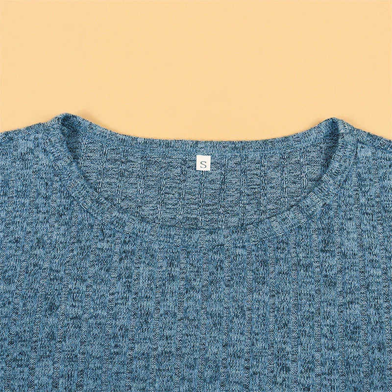 Close-up of the blue ribbed fabric and round neckline of a maternity sweater
