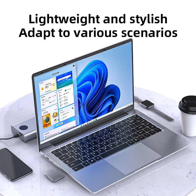 A silver thin laptop displayed on a desk with accessories like a power bank, watch, phone, and coffee cup.