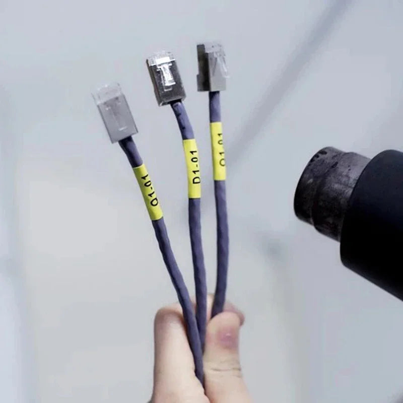 Using a heat gun to shrink yellow cable labels on ethernet network cables