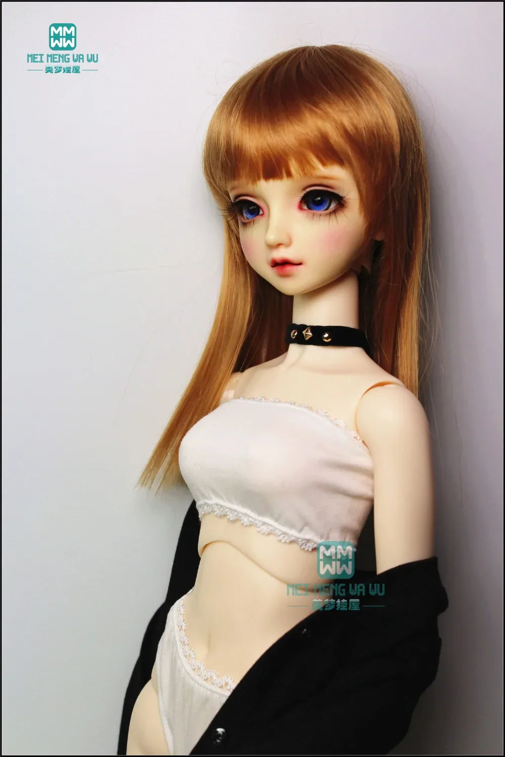 A BJD doll wearing a white tube top and matching white briefs with a black cardigan