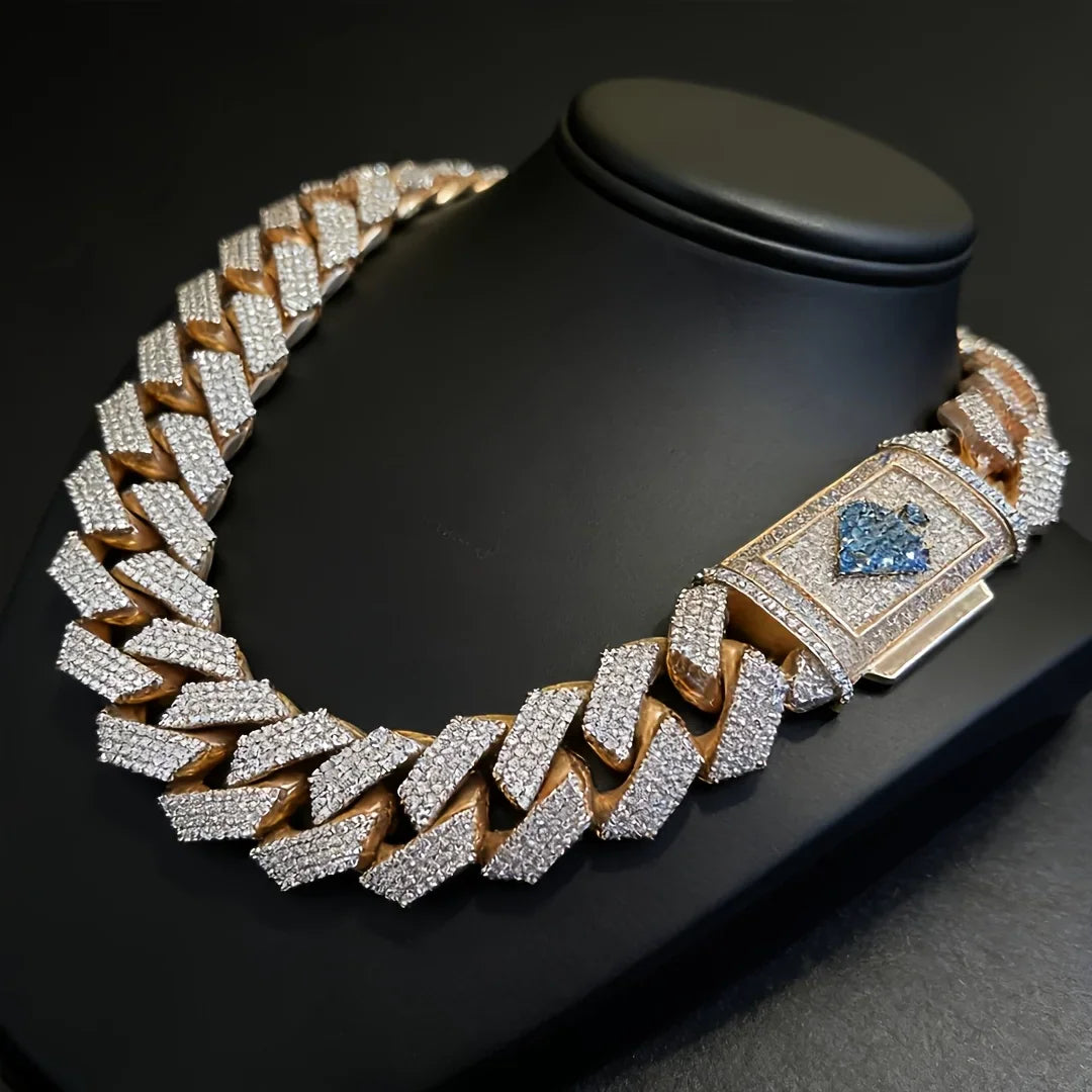 Rose gold cuban link necklace with diamond-like stones and spade emblem on clasp on black display stand