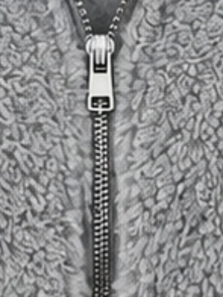 Detail of the metal half-zip closure on the gray fuzzy fleece hoodie.