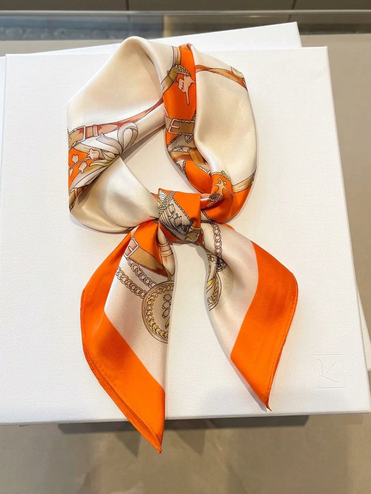 White and orange silk square scarf with equestrian chain and belt pattern