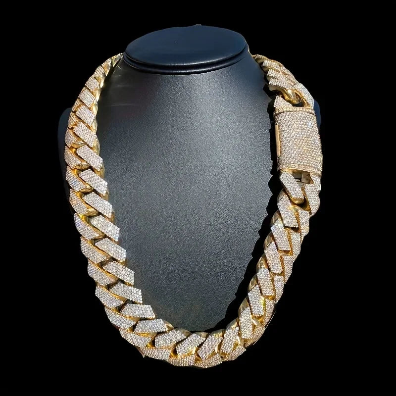 Close-up detail of a thick gold-tone Cuban link chain with pave cubic zirconia stones