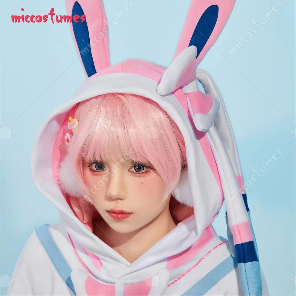 Close up of a person wearing a pink and white cosplay hoodie with a bunny ear hood and pink hair