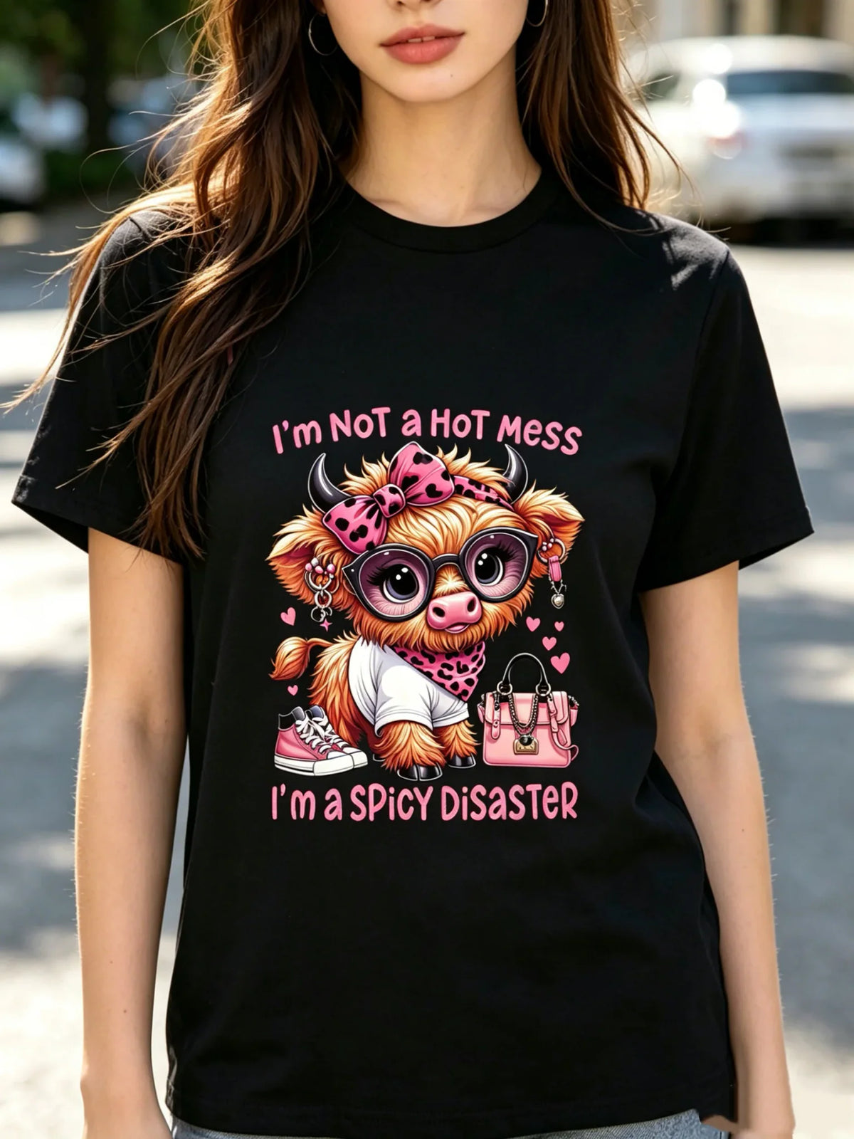 Woman wearing a black t-shirt with a Highland cow graphic print