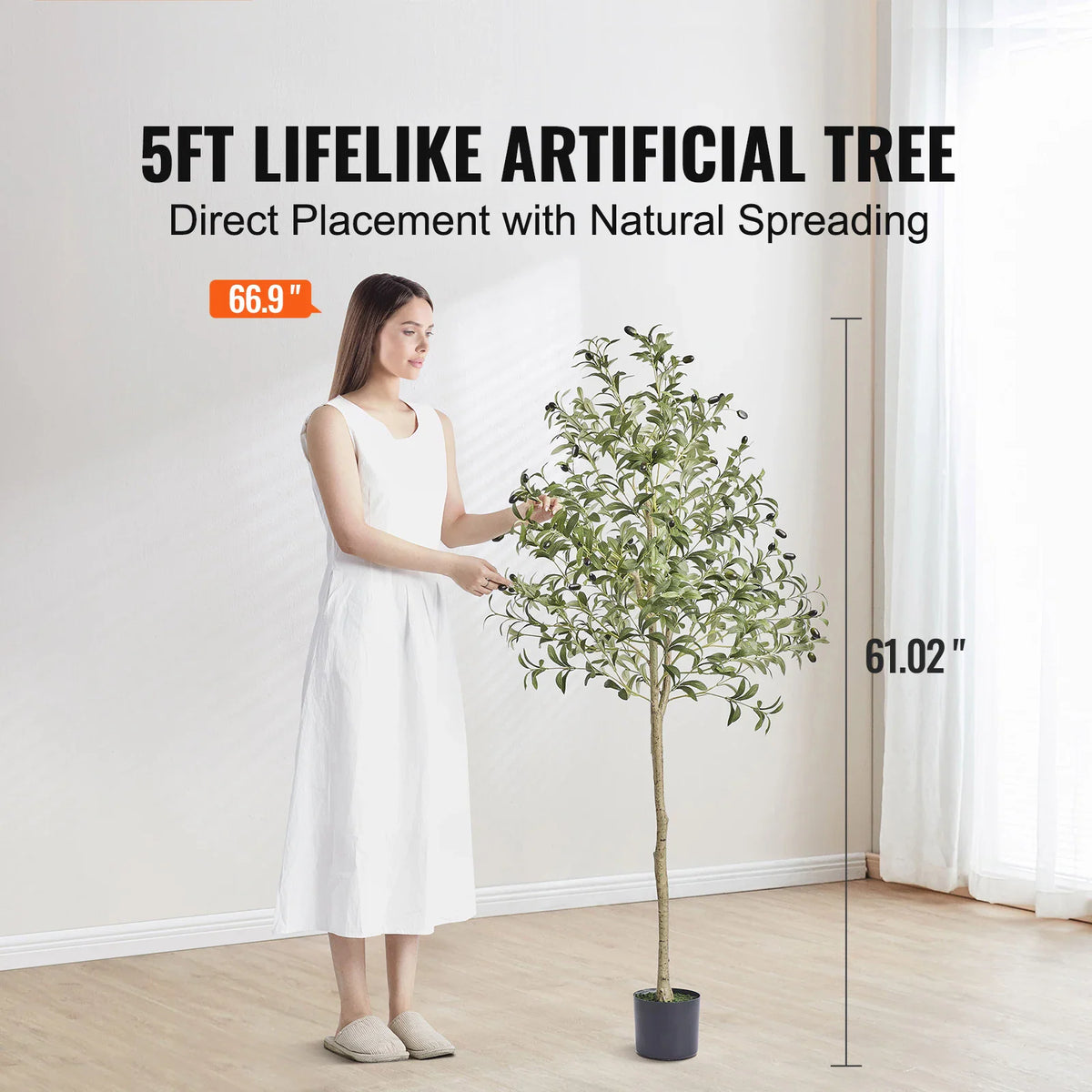 A woman standing next to a 5ft artificial olive tree showing size dimensions.