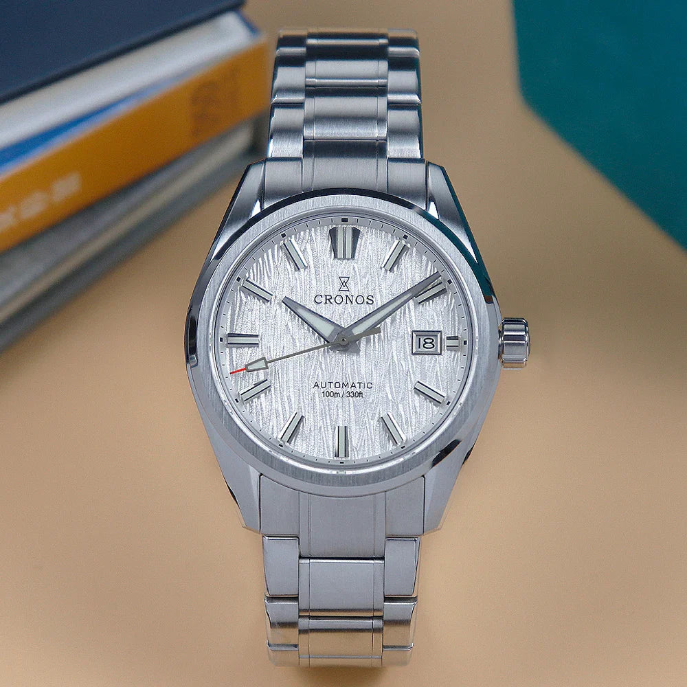 A front view of a stainless steel men's automatic wristwatch with a white birch-textured dial and metal link bracelet.