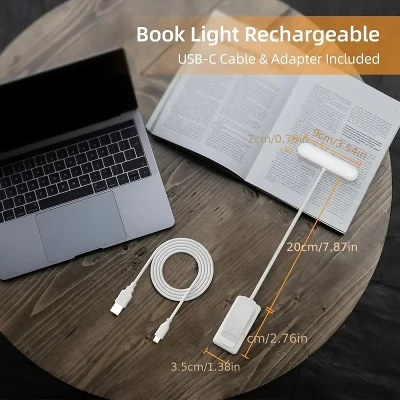 Rechargeable clip-on reading light with USB-C cable displayed on a desk next to a laptop and book