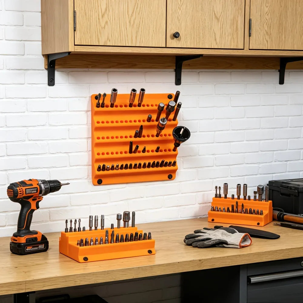 Multiple orange tool organizer racks holding screwdriver bits on a workshop wall and workbench.