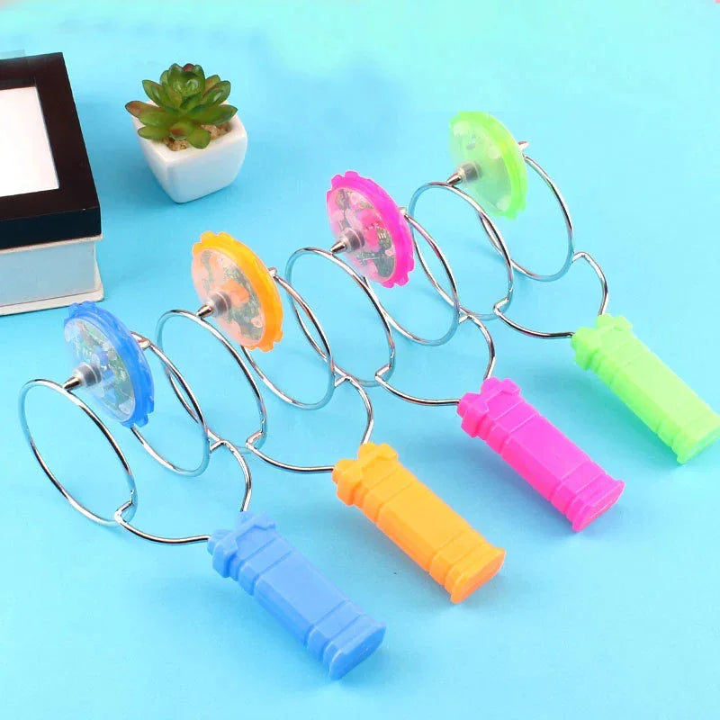 Set of four magnetic spinning top toys with LED lights and colored handles