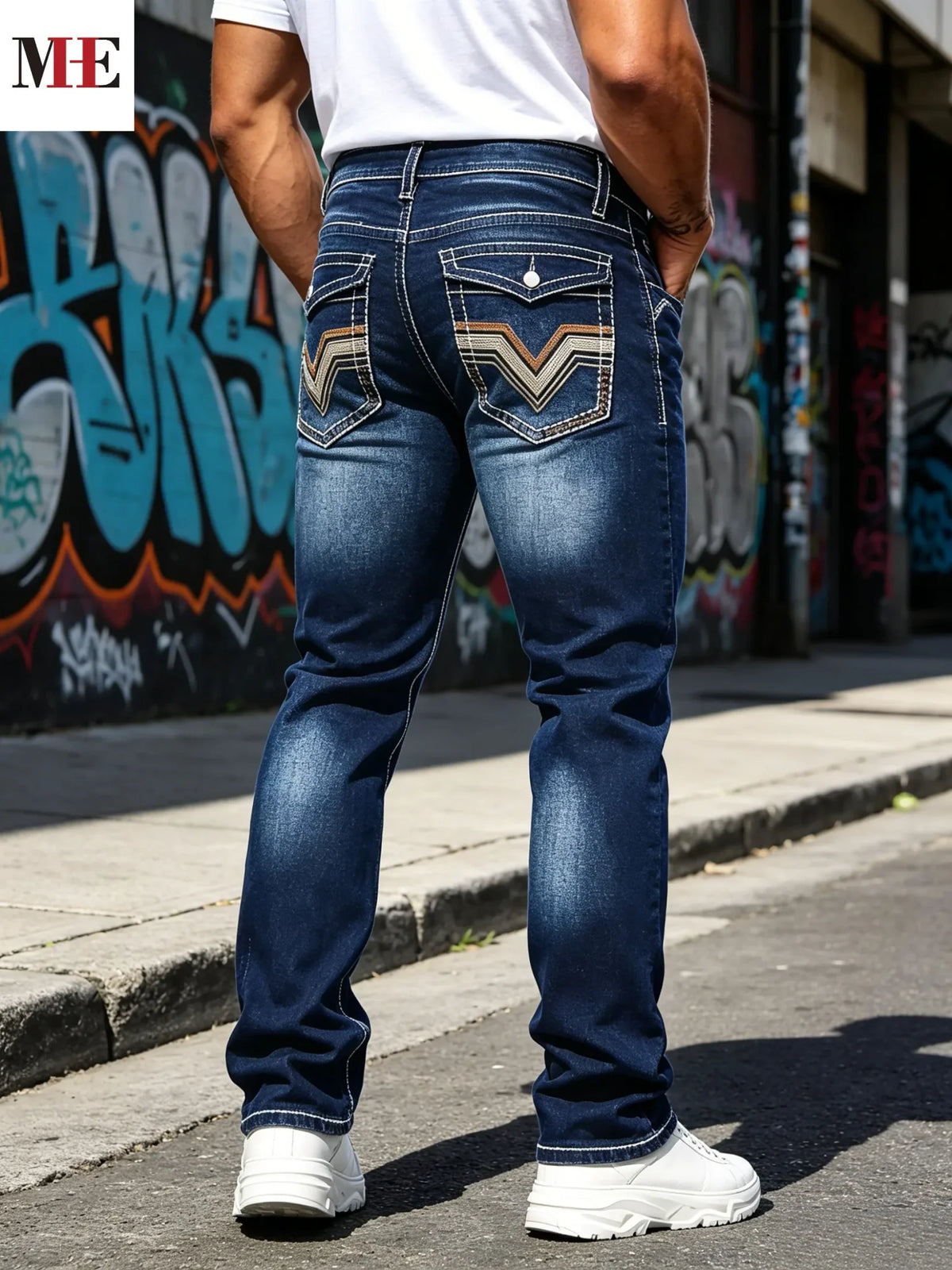 Back view of slim fit dark blue jeans with V-stitched back pockets, white t-shirt and white sneakers