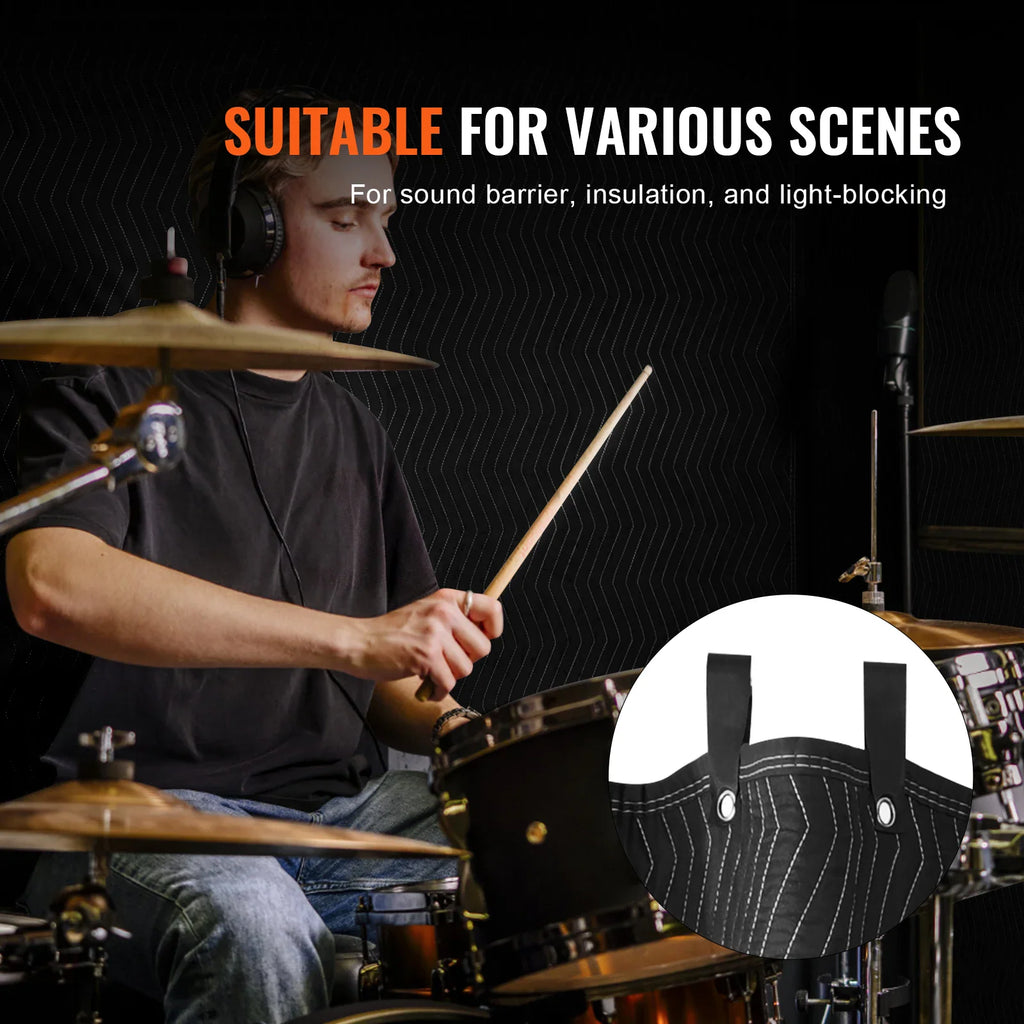A musician playing drums in a room sound-proofed with black acoustic blankets