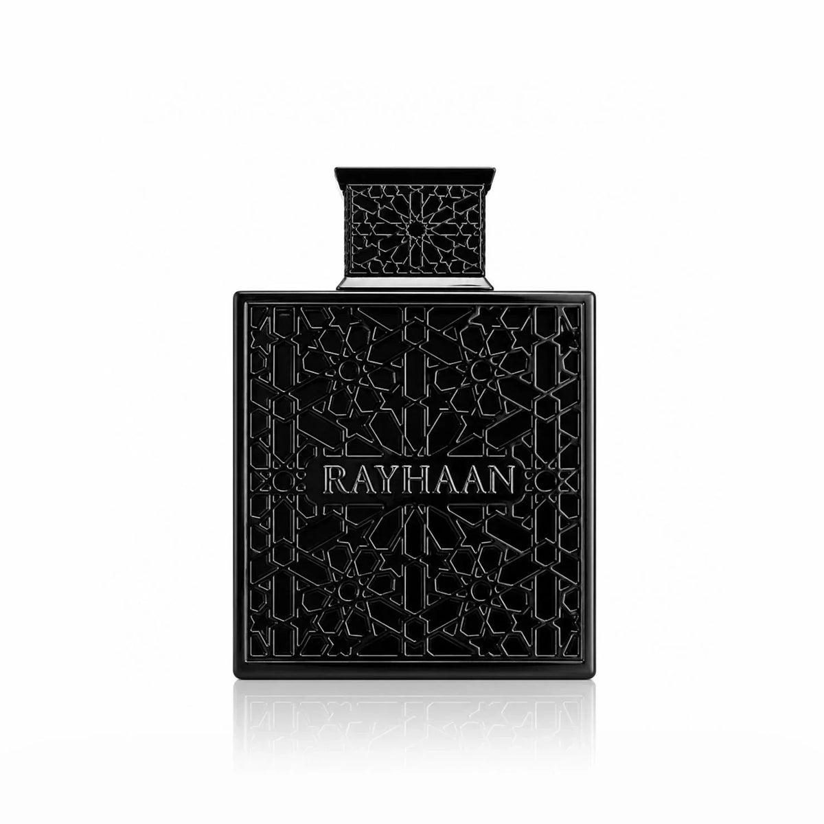 Black square perfume bottle with intricate relief texture and reflection against a white background