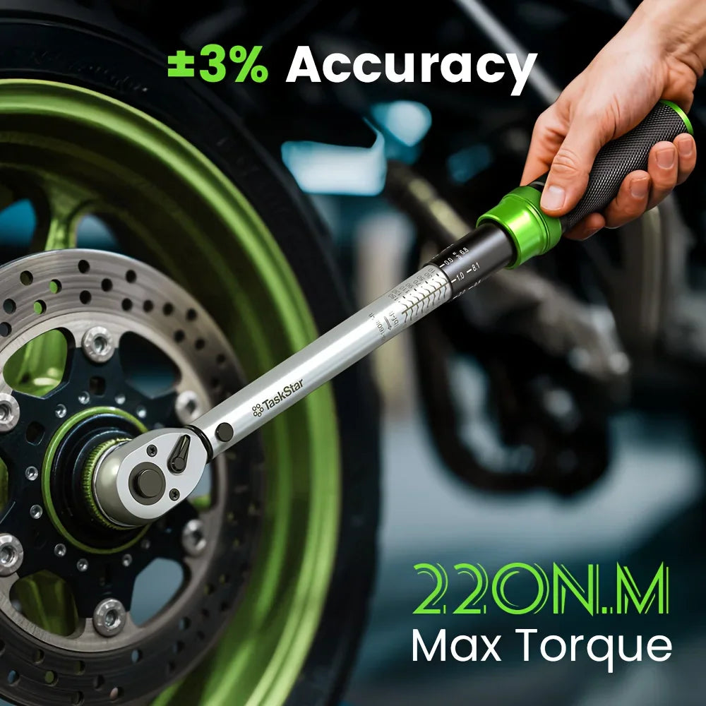 A person using a torque wrench on a motorcycle wheel.