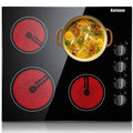Electric ceramic stovetop with four glowing burners and a pot of soup on the surface