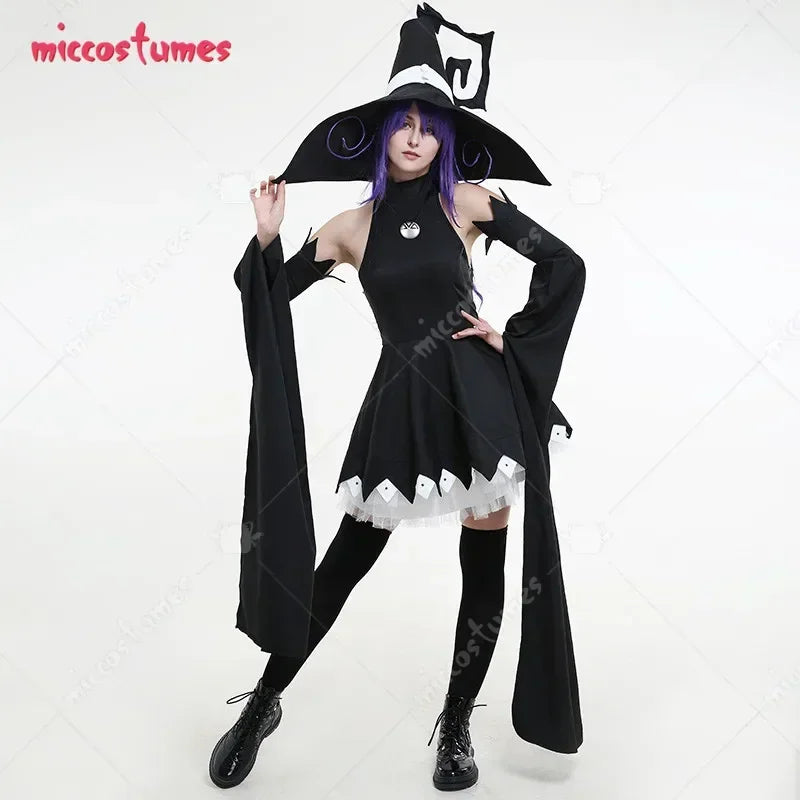 A woman wearing a full black witch cosplay costume with a pointed hat and long oversleeves