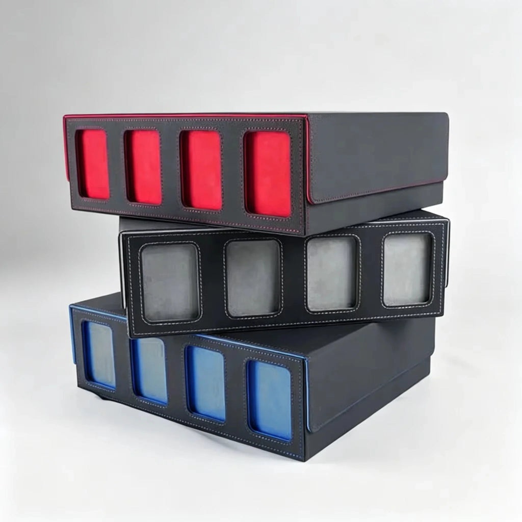 A stack of three trading card storage boxes with red, grey, and blue interior linings.