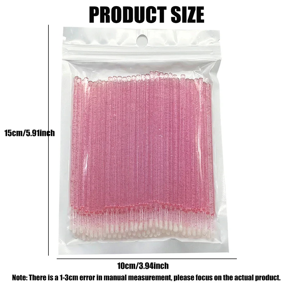 A clear bag of pink disposable eyelash cleaning microbrushes with size measurements in centimeters and inches.