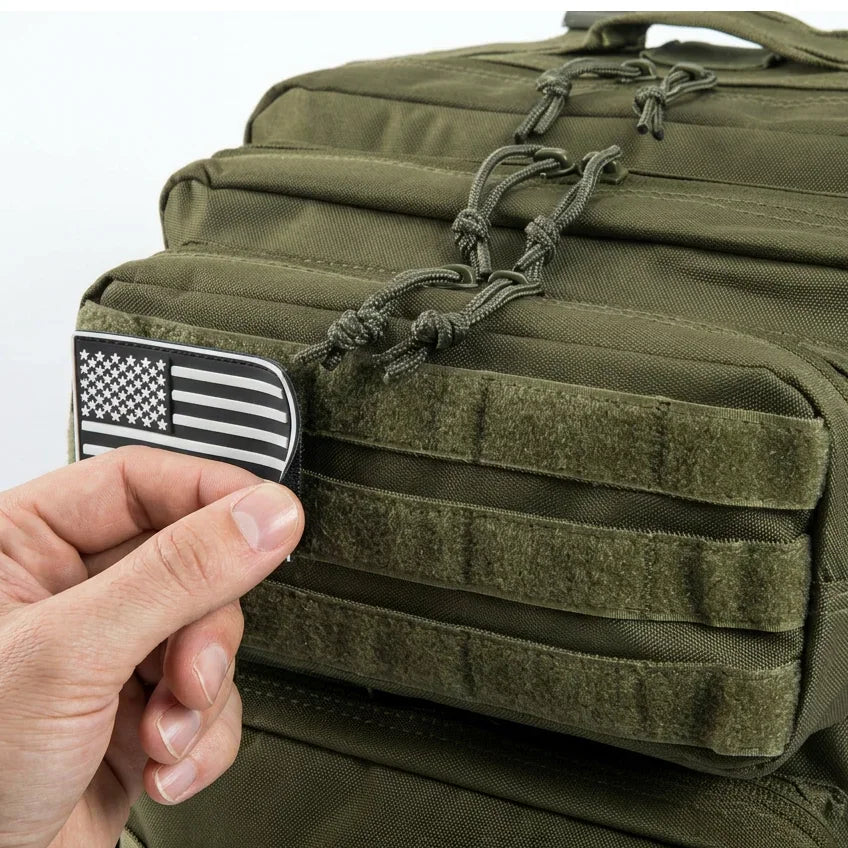 Close up of hand adjusting a flag patch on a tactical gym backpack