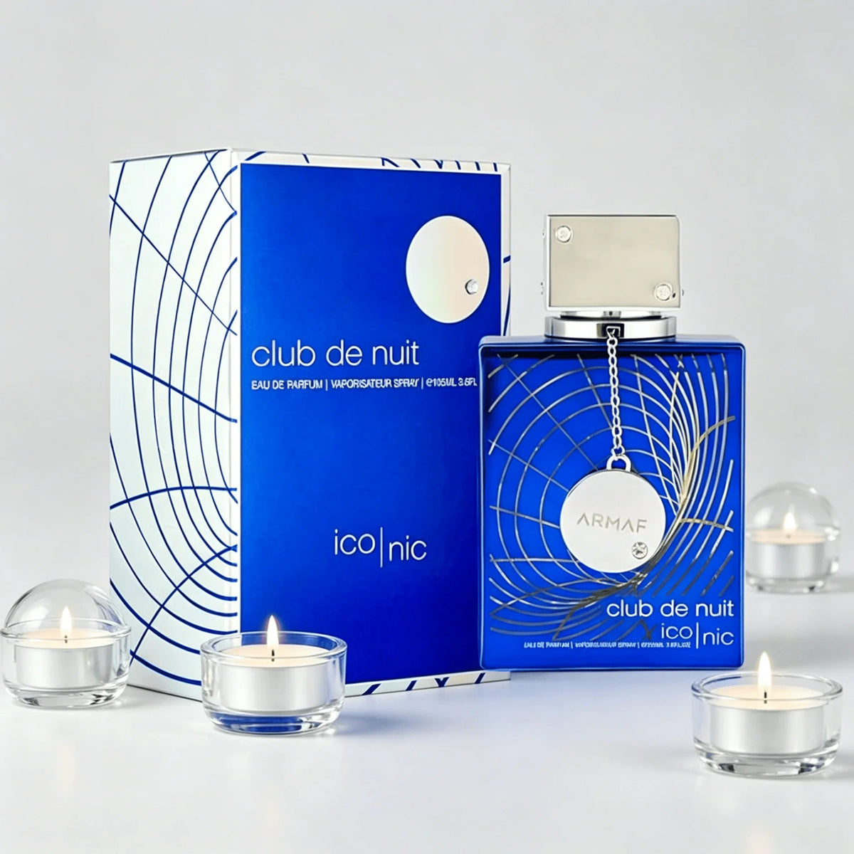 Blue perfume bottle and box decorated with small glass tea light candles.