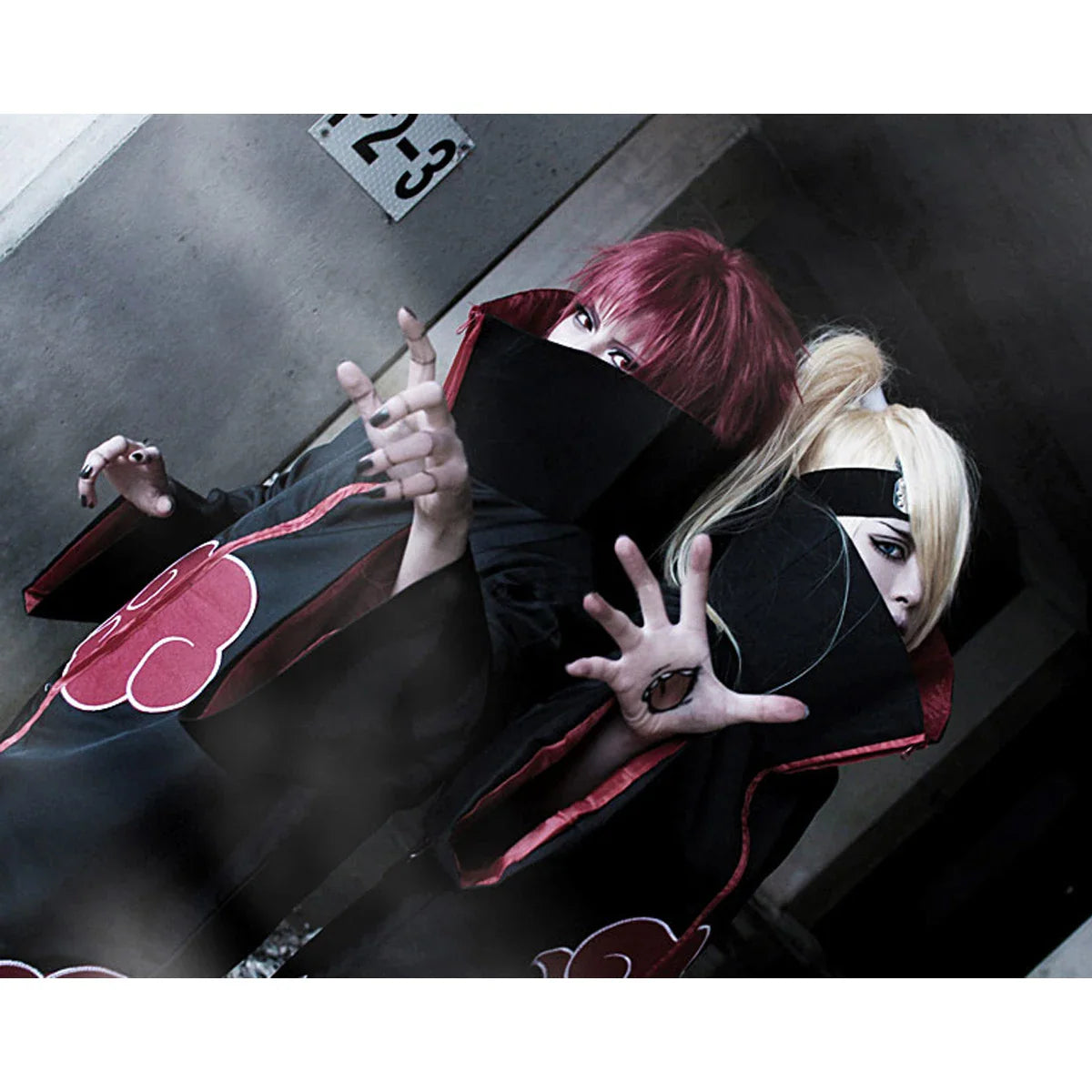 People wearing black cloaks and cosplay accessories