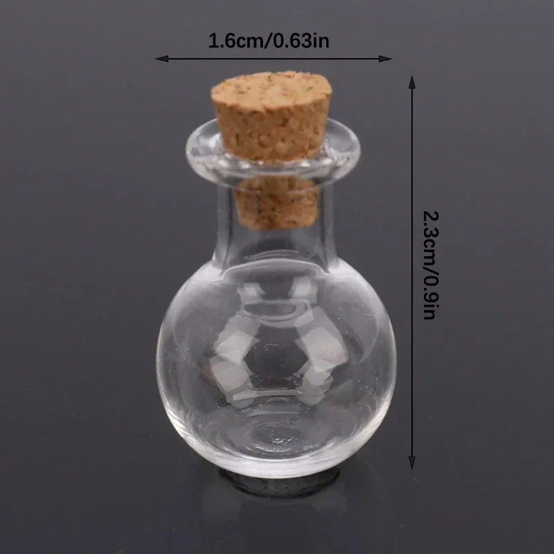 Close-up of a small glass bottle with a cork stopper showing dimensions in centimetres and inches