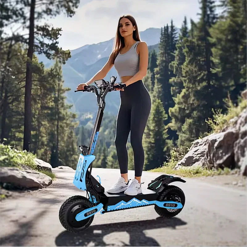 Woman standing on an electric scooter on a scenic mountain road