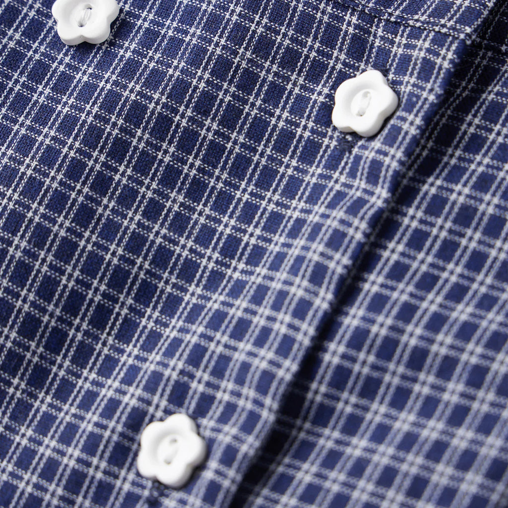 Close-up of blue and white plaid shirt with flower-shaped buttons